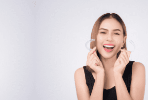 The female patient at Banyule Dental is holding her clear aligners