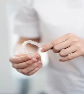 The dentist at Banyule Dental holds the Invisalign clear aligner