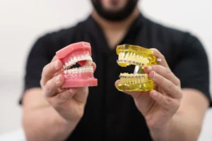 The Banyule Dental dentist demonstrating devices for teeth straightening
